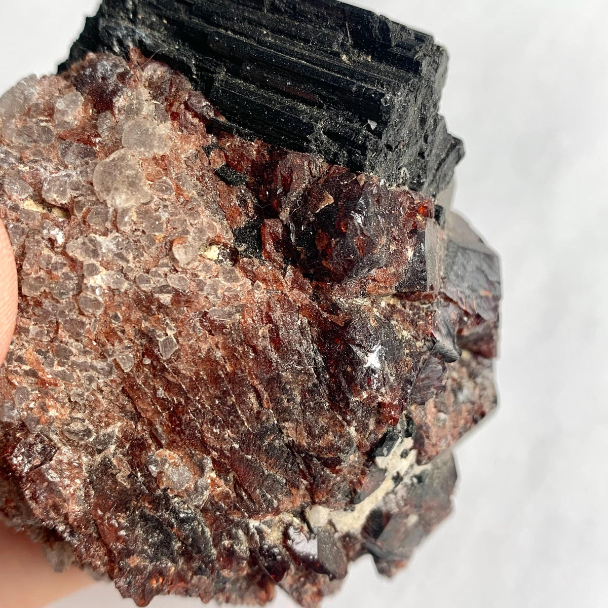 Natural garnet crystals with prismatic black tourmaline