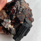 Red garnet and black tourmaline geological specimen