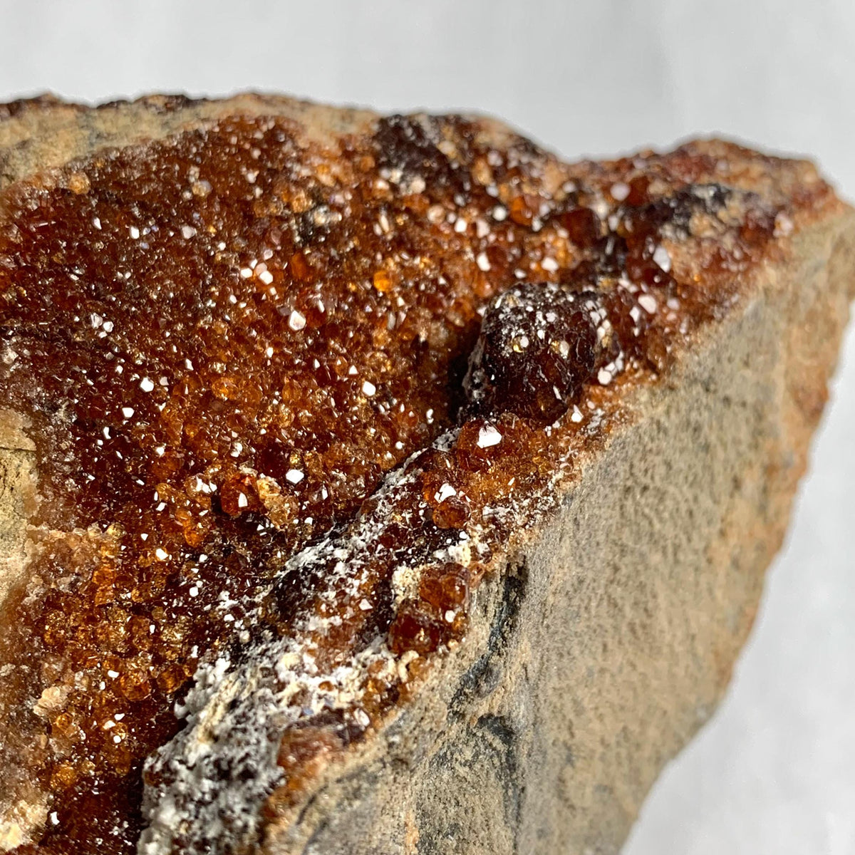 Natural garnet crystals embedded in rock matrix