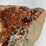 Natural garnet crystals embedded in rock matrix
