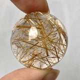 Natural rutilated quartz crystal ball display
