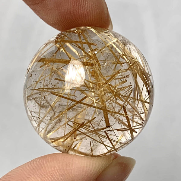 Natural rutilated quartz crystal ball display