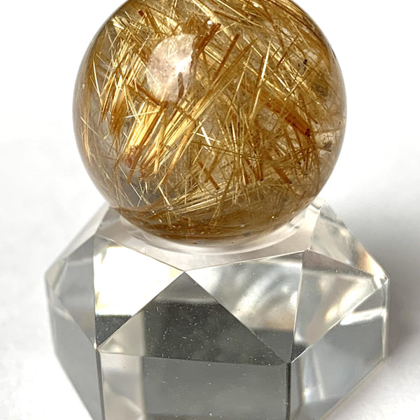 Rutilated quartz sphere with golden needles