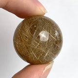 Golden rutile needle quartz sphere close up
