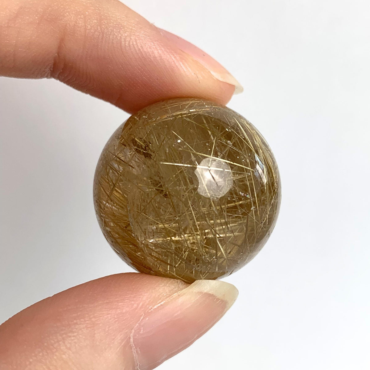 Clear quartz sphere with golden rutile inclusions
