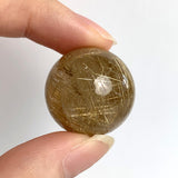 Clear quartz sphere with golden rutile inclusions