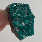 vivid emerald dioptase crystals on natural matrix