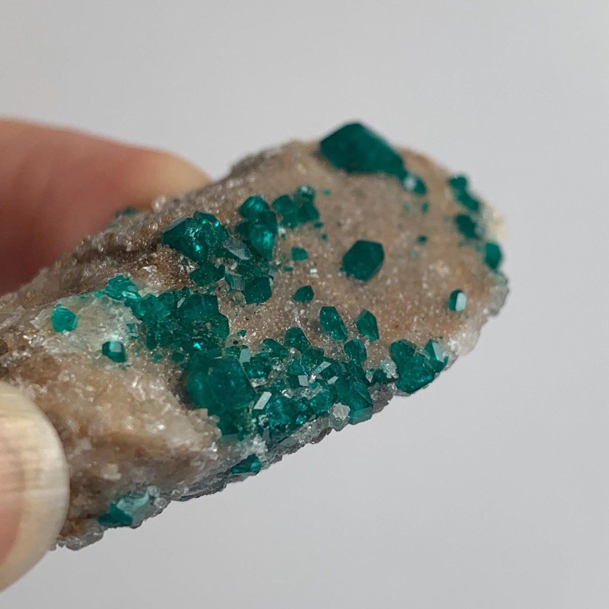 dioptase mineral with crystals on rock
