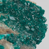 emerald green dioptase specimen crystals both sides