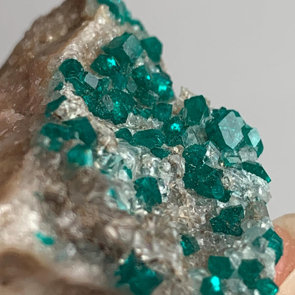 emerald green dioptase specimen on matrix
