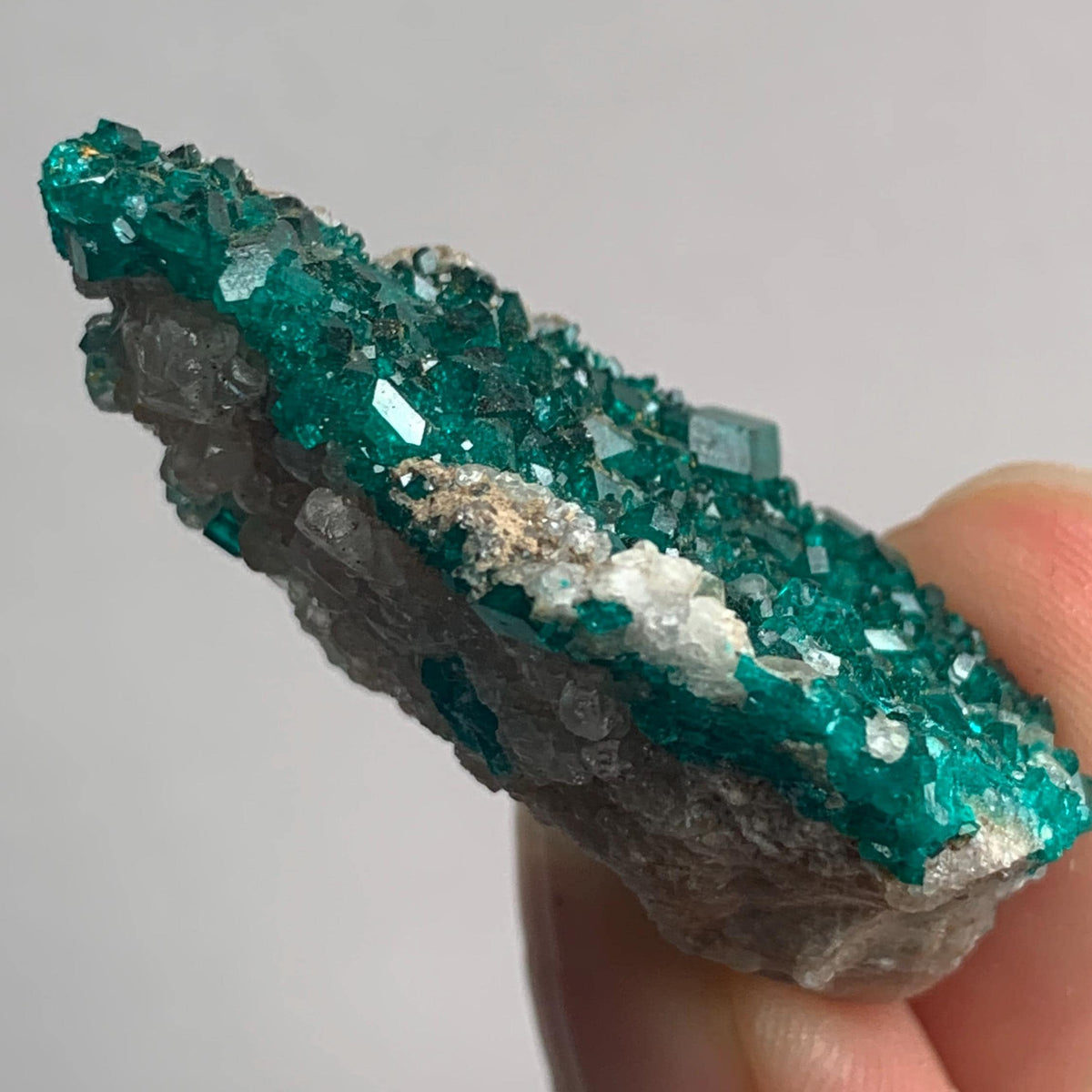 sparkling emerald dioptase crystal surface rock