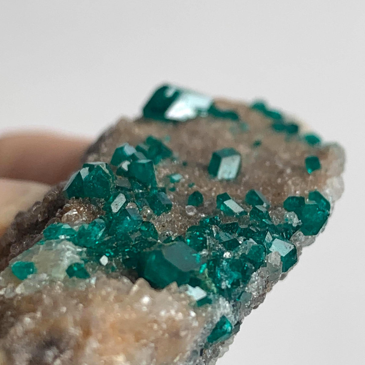 bright emerald dioptase crystal points on rock