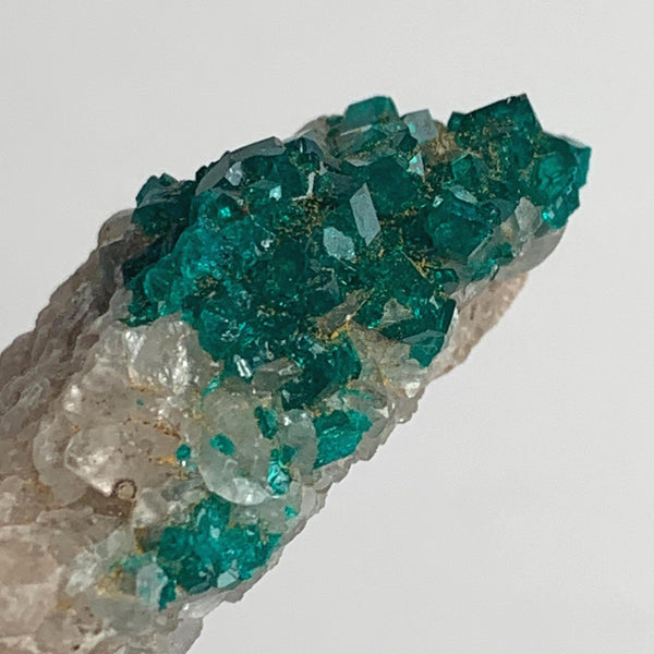 vivid green dioptase crystals on rock matrix