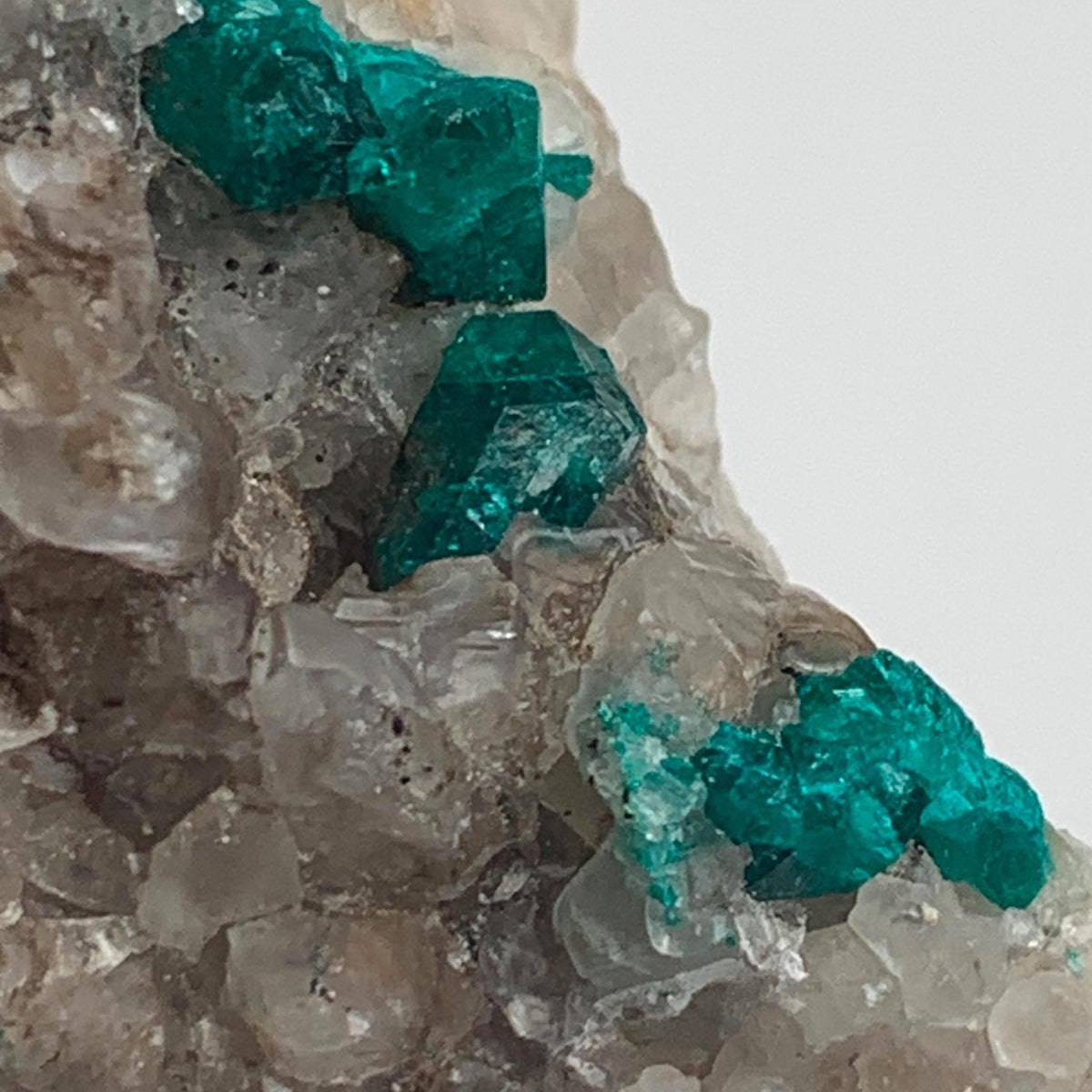 sparkling emerald dioptase cluster on rock