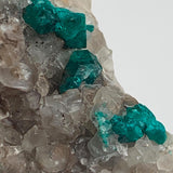 sparkling emerald dioptase cluster on rock