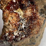 Large garnet cluster on stone matrix close-up view