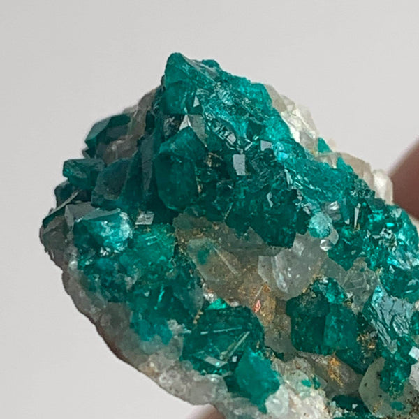 vivid green dioptase crystals on natural rock