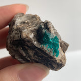 emerald green dioptase crystals on matrix specimen