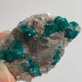 close up of rich emerald green dioptase crystals