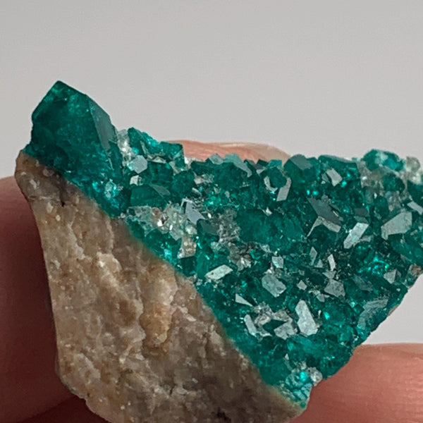 emerald green dioptase crystal face on matrix