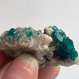 bright emerald dioptase crystals on host rock
