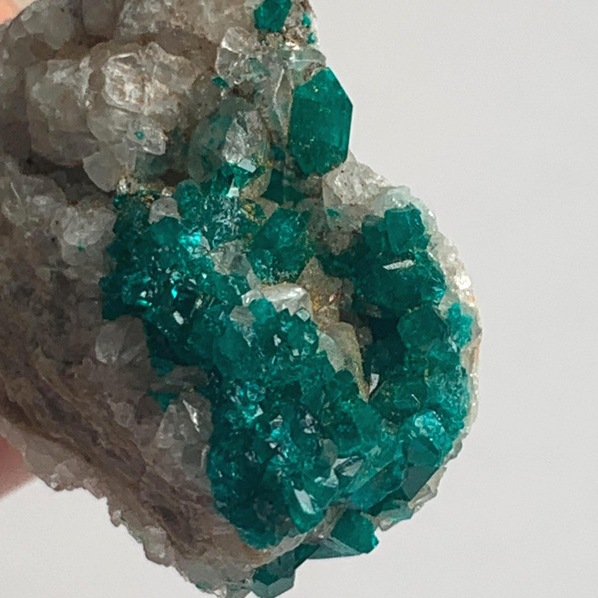 sparkling emerald dioptase crystal points on rock