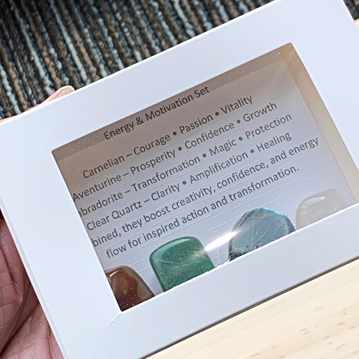Themed Energy crystal sets displayed inside open cardboard gift boxes with properties cards