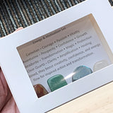Themed Energy crystal sets displayed inside open cardboard gift boxes with properties cards