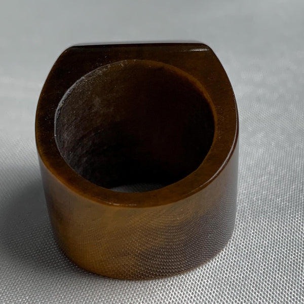 Sculptural tiger eye ring featuring a wide architectural band