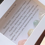 Themed healing crystal sets displayed inside open cardboard gift boxes with properties cards