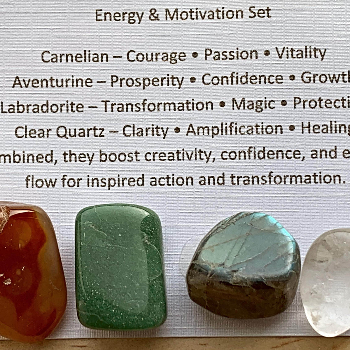Themed healing crystal sets displayed inside open cardboard gift boxes with properties cards