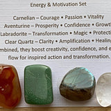 Themed healing crystal sets displayed inside open cardboard gift boxes with properties cards