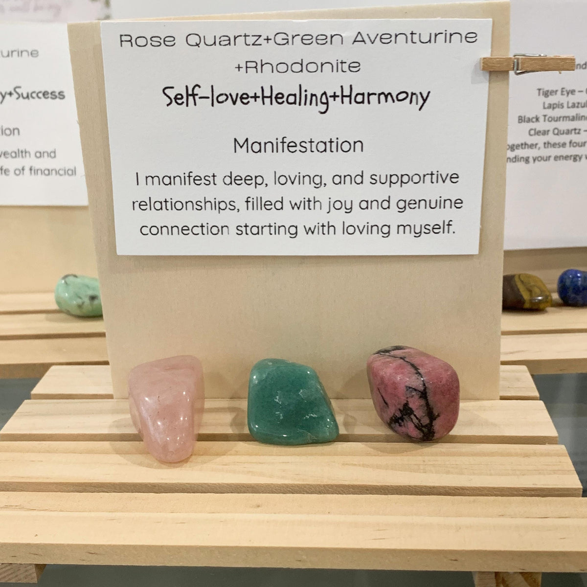 pink rose quartz and green aventurine stone over a self love affirmation card