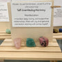pink rose quartz and green aventurine stone over a self love affirmation card