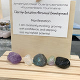 Violet amethyst cluster and flashy labradorite crystal placed beside a personal growth affirmation note