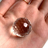 Flawless 25mm clear quartz micro faceted sphere reflecting brilliant light