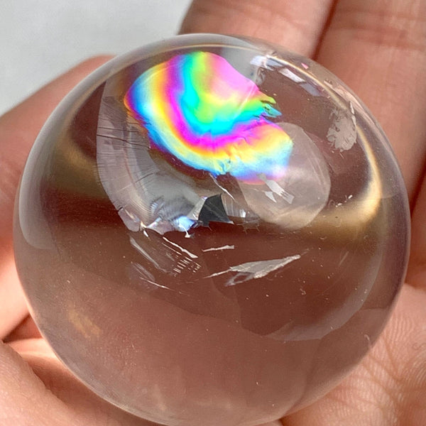 Rainbow quartz crystal sphere displayed as elegant home décor piece