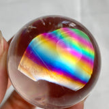 Polished rainbow quartz sphere with rare colorful internal inclusions