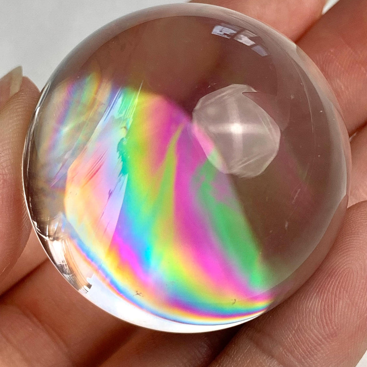 Collector quality rainbow quartz sphere weighing approximately 71 grams