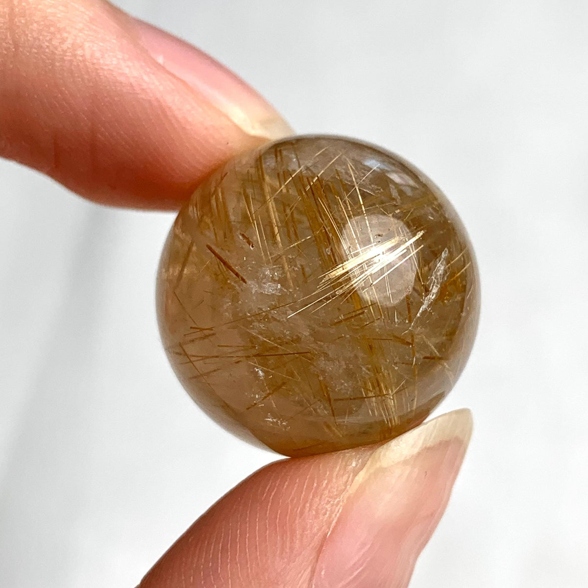 Natural rutilated quartz crystal sphere ideal for meditation and décor
