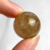 Natural rutilated quartz crystal sphere ideal for meditation and décor