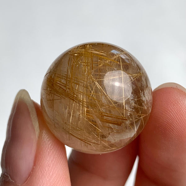 21mm polished quartz crystal ball with natural golden needle inclusions