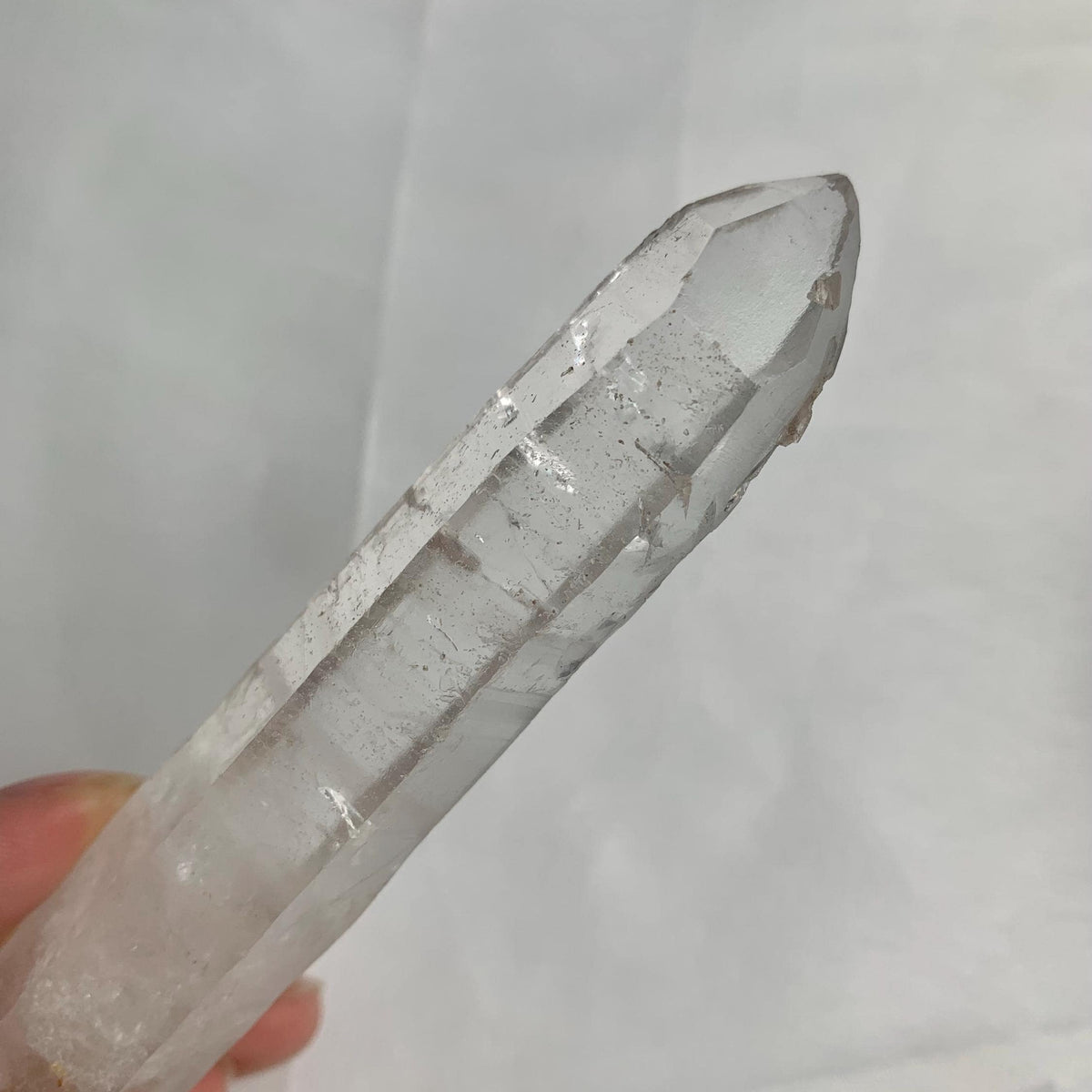 Rare double terminated quartz crystal displayed on white background