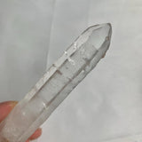 Rare double terminated quartz crystal displayed on white background