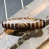 Detailed view of the unique circular markings on a genuine tibetan dragon eye talisman bead