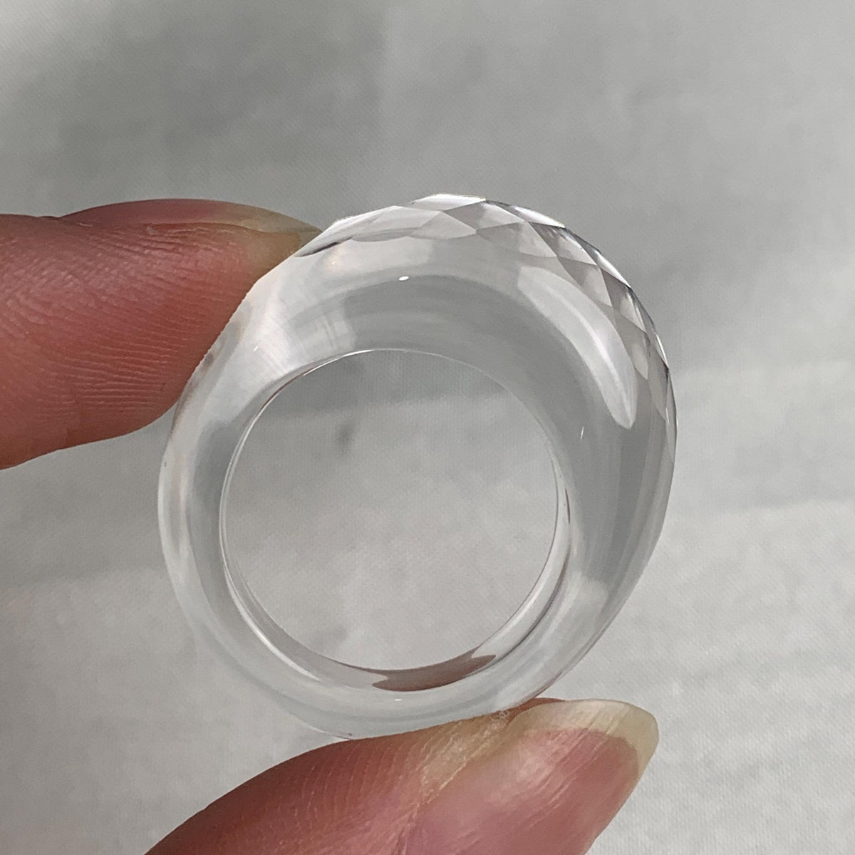 Elegant clear quartz ring with light reflecting geometric cuts