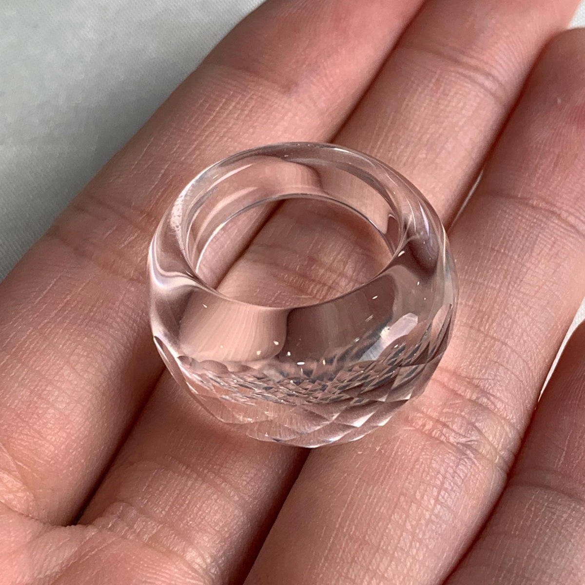 Transparent crystal ring with faceted sculptural surface