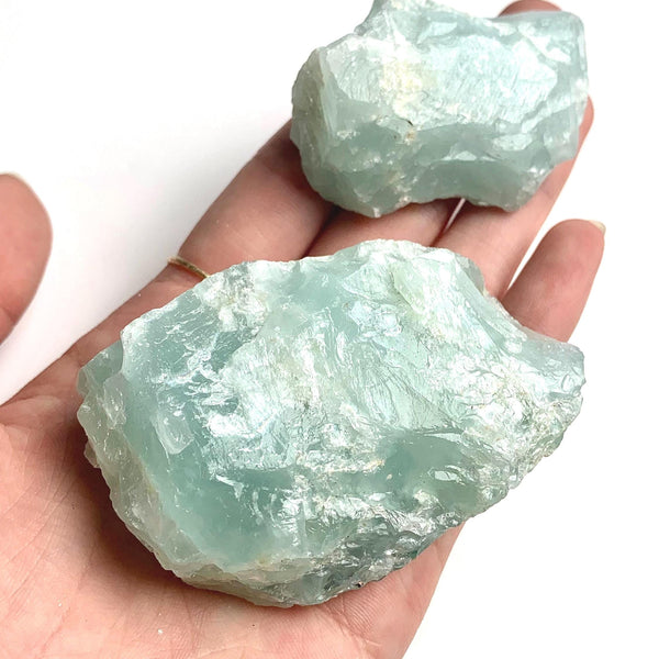Raw aquamarine crystal specimen with natural blue color and rough texture
