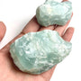 Raw aquamarine crystal specimen with natural blue color and rough texture