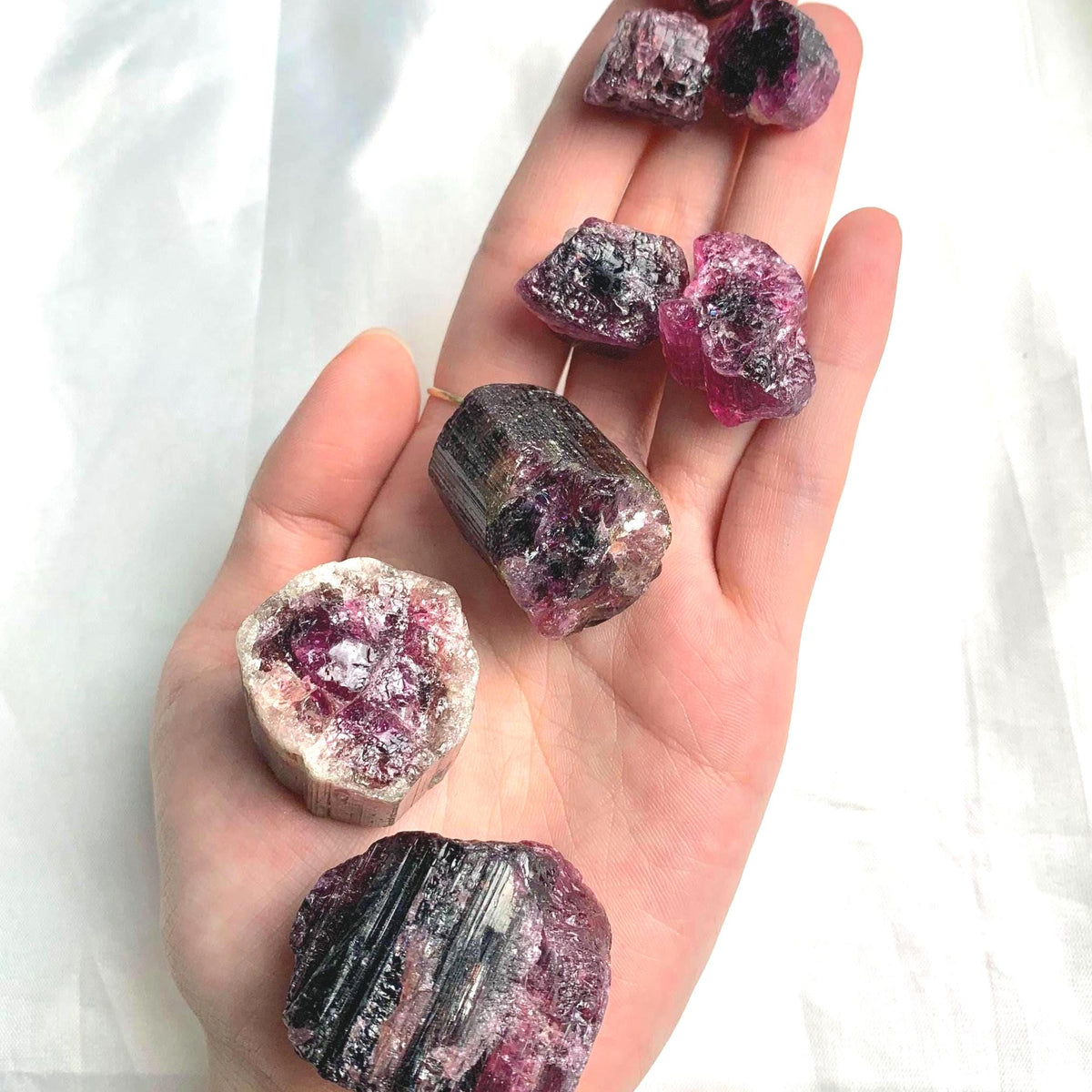 Collection of genuine pink tourmaline stones available in multiple size categories